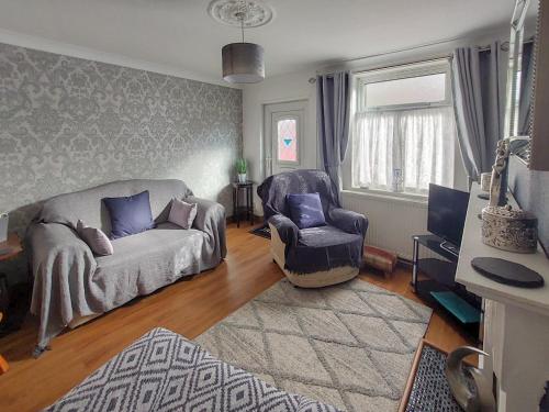 a living room with a couch and a chair at Amberley Cottage in Alfreton