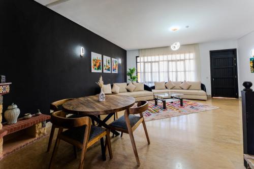 a living room with a table and a couch at MVIEW Villas in Marrakech