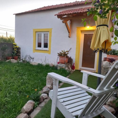 a white bench in front of a house at Villa Luna in Boa Viagem