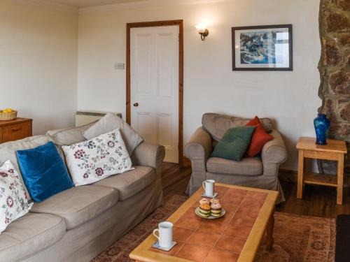 a living room with a couch and a table at Bishop Rock - Grl in Trevilley