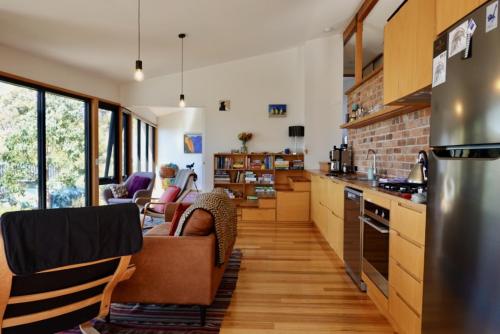 a kitchen with a couch and a counter top at The Lookout House at Pirates Bay in Eaglehawk Neck