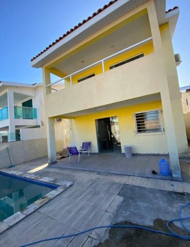 a house with a swimming pool in front of it at Iane Raquel Bezerra Barbosa in Tamandaré