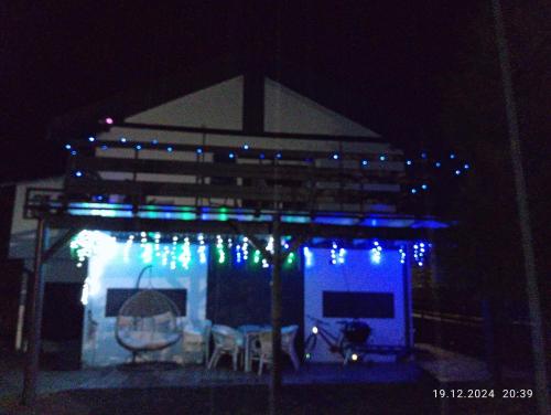 a lit up gazebo with blue and green lights at Streamside apartment in Jarkowice