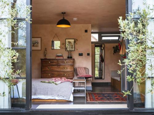 a bedroom with a bed and a desk in a room at Olive in Kelsall