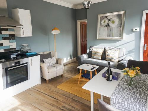 a living room with a couch and a table at Bookkeepers Place in Bakewell