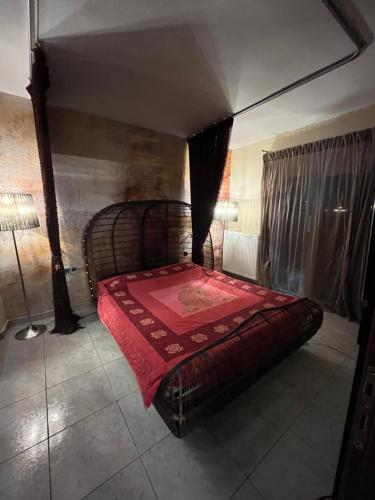 a bedroom with a large bed with a red blanket at Diamond Stay in Kilkís
