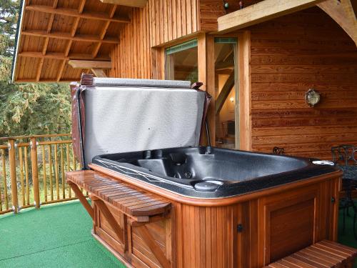 a bath tub sitting on the porch of a cabin at Mill Of Burncrook in Glenlivet
