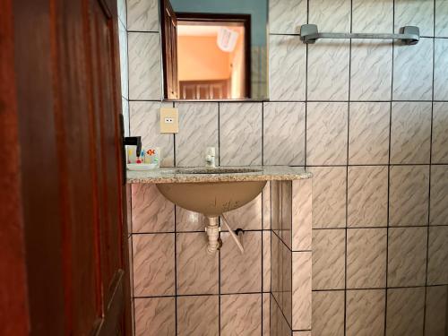a bathroom with a sink and a mirror at Bela Vista in Canoa Quebrada