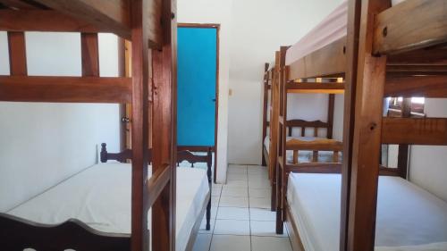 a room with two bunk beds and a hallway at Hostal Javier's House sjs in San Juan del Sur