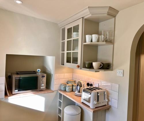 a kitchen with a counter top with a microwave at The Barn at The Manor in Cole, Bruton in Cole