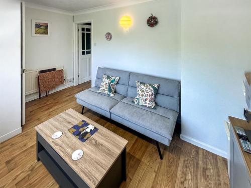 a living room with a couch and a table at The Nest - Uk46879 in Woodbury
