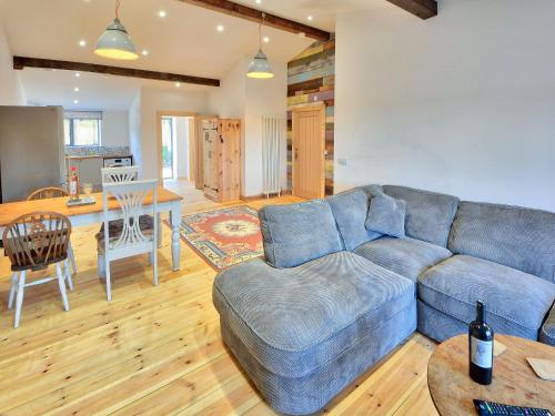 a living room with a blue couch and a table at Dornfelder - Ukc3209 in Newbridge