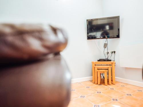 a room with a tv and a small table at Gardener's Cottage - Uk6713 in Lydstep