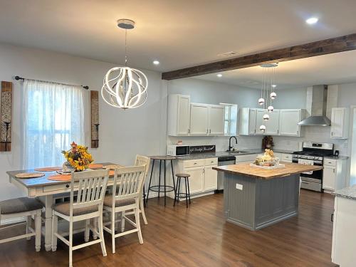 a kitchen with white cabinets and a table with chairs at My house your house in Fort Smith