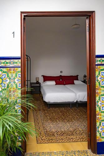 a bedroom with a bed and a large doorway at La Centenaria 1920 in Telde