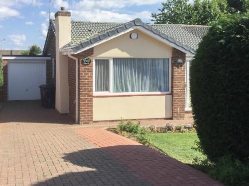 ein Haus mit einem Fenster und einer steinernen Einfahrt in der Unterkunft The Briar Rose in New Herrington