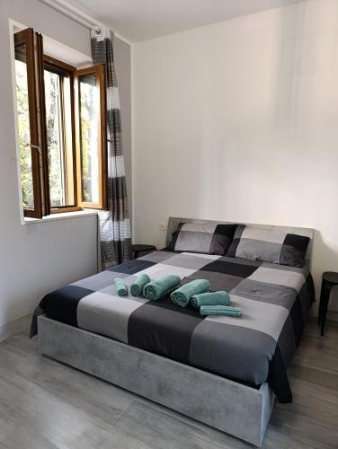 a bedroom with a large bed with blue pillows at MT-Apartments in Bollate