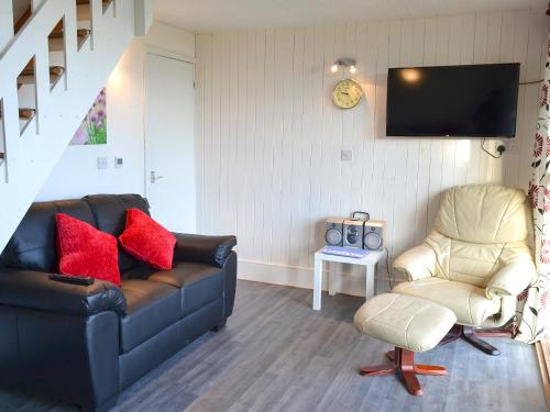 a living room with a couch and a chair at Bay View in Kingsdown