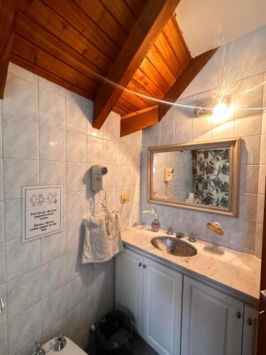 a bathroom with a sink and a mirror at Why Not Guemes in Córdoba
