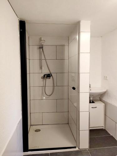 a bathroom with a shower and a sink at Südeifel Spangdahlem in Spangdahlem