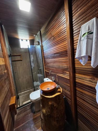 a bathroom with a toilet and a sink in a log at Hotel e Restaurante Tribo Combú in Belém