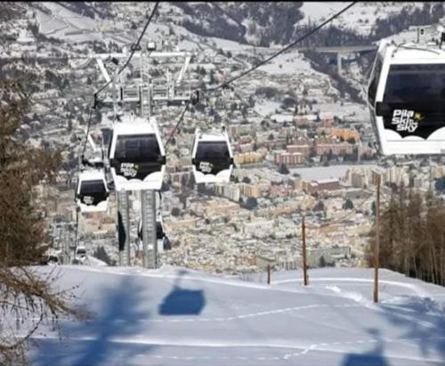 three gondolas on a ski lift in the snow at casa rita in Gressan