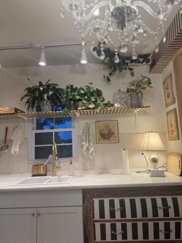 a kitchen with a sink and a chandelier at 5 BR 4 Bath Dutch Cottage 3 ml from Buffalo Trace in Frankfort