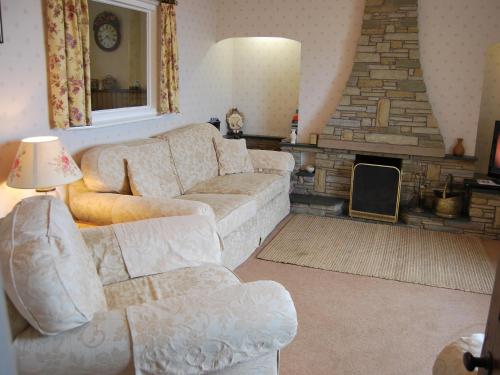 a living room with a couch and a fireplace at Shore Cottage in Silverdale