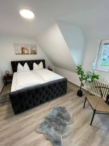 a bedroom with a large bed in a attic at HarzRoots A mit Garage in Bad Harzburg