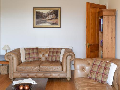 a living room with a couch and a table at Lake View Apartment in Bowness-on-Windermere