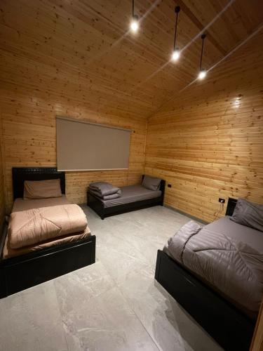 a room with two beds and a projection screen at Cherry hut in Ajloun