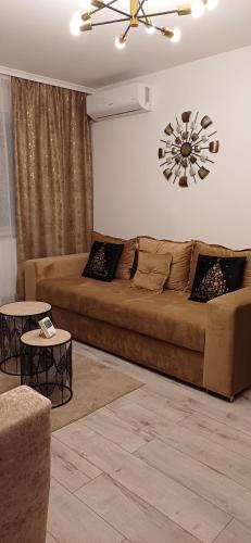 a living room with a large couch and a table at Cozy Place in Craiova