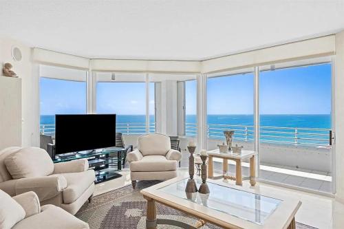 a living room with a view of the ocean at Spacious Three-Bedroom Oceanfront Apartment with Panoramic Views in Pompano Beach
