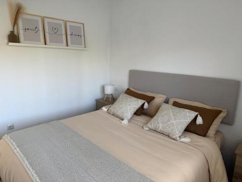 a bedroom with a bed with two pillows on it at Mirador del Sol - Sea View Apartment Torrox in Torrox