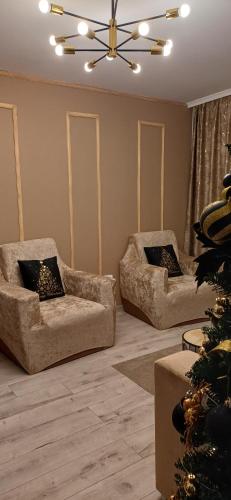 a living room with two couches and a christmas tree at Cozy Place in Craiova
