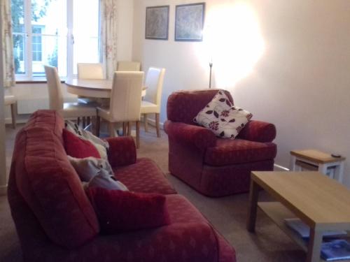 a living room with a couch and chairs and a table at Haystacks in Bowness-on-Windermere