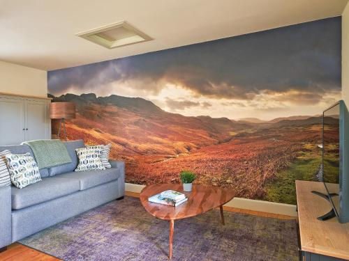 a living room with a large painting on the wall at Midcraigs in Kilchenzie