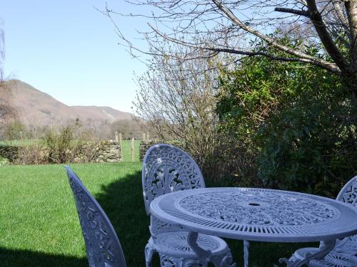 a table and chairs sitting in the grass at Field House Lodge in Borrowdale Valley
