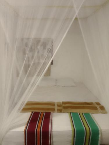 a bed with a canopy in a room at Imaa freedom house in Nilwella