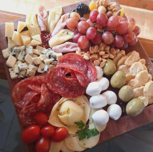 a tray of different types of food on a table at Chales Estância Verdejante in Sapucaí-Mirim