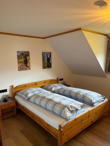 a bedroom with two beds in a attic at Ferienwohnung Lahnerhof in Arriach
