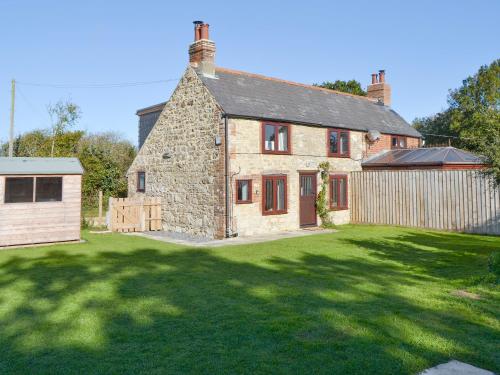 an old stone house with a large yard at Southview in Porchfield