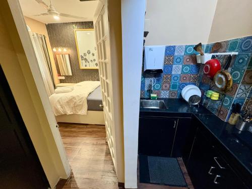 a small kitchen with a sink and a bedroom at 1BHK CASA BELLA Off Linking rd Ground floor in Mumbai