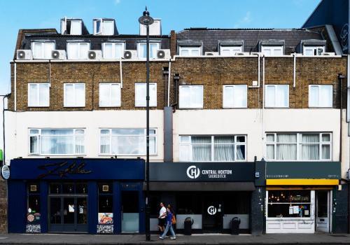 two people walking in front of a building at Central Hoxton Shoreditch in London