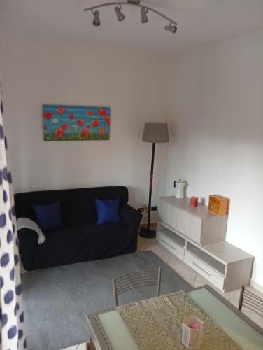 a living room with a couch and a table at B&B Rivoli in Rivoli