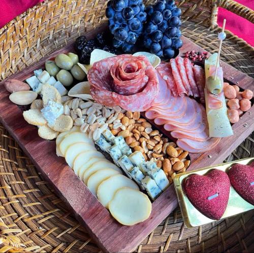 a tray of different types of food on a table at Chales Estância Verdejante in Sapucaí-Mirim