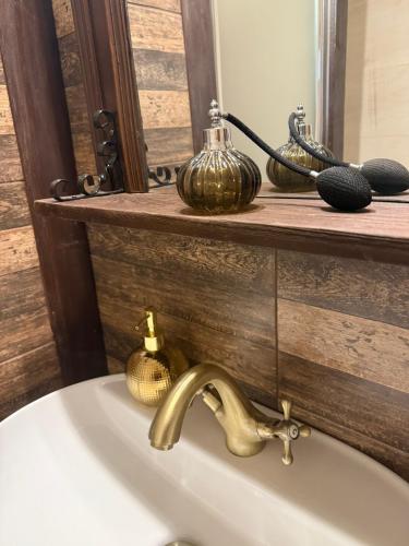 a bathroom sink with a faucet and a mirror at Apartmán Arkona in Slovenská ľupča