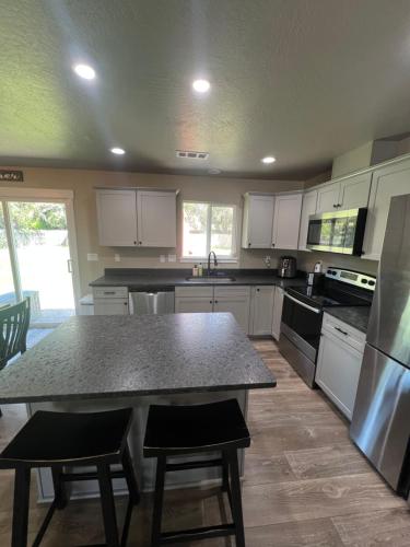 a kitchen with a table and some chairs in it at Rest and Retreat River House in Grants Pass