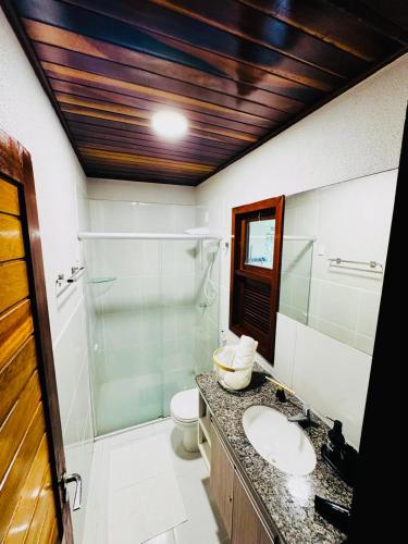 a bathroom with a sink and a toilet and a shower at Chale Pitanga 38 in Pipa