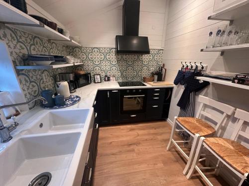 a kitchen with a sink and a stove at Bagargården 8 in Åre